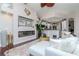 Bright, open-concept living room features a fireplace, recessed lighting, and stylish decor at 27045 Firebush Dr, Wesley Chapel, FL 33544