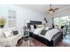 Main bedroom features a platform bed, hardwood floors, high ceilings, and lots of natural light at 27045 Firebush Dr, Wesley Chapel, FL 33544