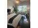A serene main bedroom with a king-size bed, ample natural light, and stylish furnishings, creating a relaxing retreat at 27045 Firebush Dr, Wesley Chapel, FL 33544