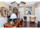 Office featuring dark wood floors, a large desk, and unique decorative items, creating a distinctive workspace at 27045 Firebush Dr, Wesley Chapel, FL 33544