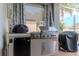Built-in outdoor kitchen featuring stainless steel grill and refrigeration at 27045 Firebush Dr, Wesley Chapel, FL 33544