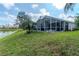 Screened patio overlooking the beautiful backyard and serene pond at 27045 Firebush Dr, Wesley Chapel, FL 33544