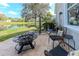 Outdoor patio with a cozy fire pit and relaxing swing, overlooking a peaceful pond view at 27045 Firebush Dr, Wesley Chapel, FL 33544