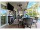 Outdoor patio with a fireplace, bar seating, and a clear view of the pool at 27045 Firebush Dr, Wesley Chapel, FL 33544