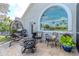 Charming patio featuring comfortable seating, a fire pit, and serene views of the surrounding landscape at 27045 Firebush Dr, Wesley Chapel, FL 33544