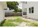 The backyard is spacious and green, with a new home on the right and a wood fence at 5327 6Th N Ave, St Petersburg, FL 33710