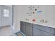 Bathroom featuring a dual vanity with gray cabinetry and an ensuite bathroom at 5327 6Th N Ave, St Petersburg, FL 33710