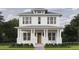 Charming two-story home featuring a welcoming front porch with stately columns and a well-manicured lawn at 5327 6Th N Ave, St Petersburg, FL 33710