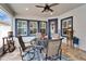 Covered patio with a ceiling fan, dining table, and view of the home's painted window trim at 609 Winterside Dr, Apollo Beach, FL 33572