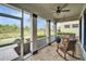 Relaxing screened-in porch with comfortable rocking chairs and a serene view of the lush, green surroundings at 609 Winterside Dr, Apollo Beach, FL 33572