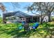 There is a fire pit with chairs and view of the home's pool in this backyard at 7425 118Th Dr, Largo, FL 33773