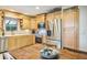 Modern kitchen with stainless steel appliances, light wood cabinetry, and a cozy dining area at 7425 118Th Dr, Largo, FL 33773