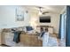 Cozy living room with a large sectional sofa, ceiling fan, and entertainment center, perfect for relaxation at 7425 118Th Dr, Largo, FL 33773