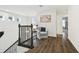 Upstairs hallway with wood floors, chair, table, and natural light from nearby windows at 7491 Notched Pine Bnd, Wesley Chapel, FL 33545