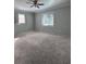 Spacious bedroom featuring neutral carpet, ample natural light from two windows, and a ceiling fan at 8139 38Th N Ave, St Petersburg, FL 33710