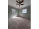Cozy bedroom with neutral carpeting, two windows providing natural light, and a ceiling fan at 8139 38Th N Ave, St Petersburg, FL 33710