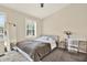 Cozy bedroom filled with natural light, showcasing a comfortable bed, stylish desk, and a full-length mirror at 8541 Hunters Key Cir, Tampa, FL 33647