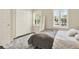 Relaxing bedroom featuring two windows, closet, and a comfortable bed with a plush area rug at 8541 Hunters Key Cir, Tampa, FL 33647