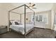 Inviting bedroom with a four-poster bed, plantation shutters, and stylish matching dresser at 8541 Hunters Key Cir, Tampa, FL 33647