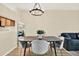 Light filled dining room featuring a modern light fixture and wood flooring at 8541 Hunters Key Cir, Tampa, FL 33647
