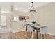 Light filled dining room featuring a modern light fixture and wood flooring at 8541 Hunters Key Cir, Tampa, FL 33647