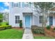 Charming home featuring a light blue front door and light blue shutters in a well manicured landscape at 8541 Hunters Key Cir, Tampa, FL 33647