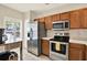 Functional kitchen features stainless steel appliances, wood cabinetry, and white countertops at 8541 Hunters Key Cir, Tampa, FL 33647