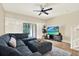 Comfortable living room features stylish seating, a ceiling fan, and a sliding glass door at 8541 Hunters Key Cir, Tampa, FL 33647