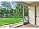 Enjoy lush green views from the screened patio featuring hanging plants and access to the backyard at 8541 Hunters Key Cir, Tampa, FL 33647
