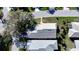 Aerial view of a home with grey roof surrounded by trees at 9233 Souchak Dr, Trinity, FL 34655