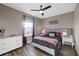 Bedroom featuring plush bedding, modern lighting, and dark wood flooring at 4188 Barbour Trl, Odessa, FL 33556