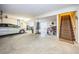 Open concept basement with concrete floor, stairs, car, and workout equipment at 54 Central Ct, Tarpon Springs, FL 34689