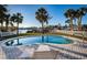 Backyard pool surrounded by lounge chairs, palm trees, and lush grass, providing a relaxing outdoor oasis at 54 Central Ct, Tarpon Springs, FL 34689