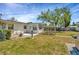 Fenced backyard featuring a patio, a small garden trellis and green grass at 540 Florida S Cir, Apollo Beach, FL 33572