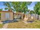 Backyard featuring shed, greenery, landscaping and outdoor oven/bbq area at 540 Florida S Cir, Apollo Beach, FL 33572