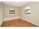 Bright bedroom featuring hardwood flooring, two windows and a closet at 540 Florida S Cir, Apollo Beach, FL 33572