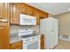 Efficient kitchen with essential appliances, wood cabinetry, and bright interiors at 540 Florida S Cir, Apollo Beach, FL 33572