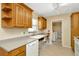 Functional kitchen featuring ample counter space, and tile floors leading to laundry room at 540 Florida S Cir, Apollo Beach, FL 33572