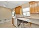 Bright kitchen featuring wooden cabinets, undermount sink, and tile flooring at 540 Florida S Cir, Apollo Beach, FL 33572