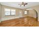 Cozy living room featuring hardwood floors, natural light, and a classic ceiling fan at 540 Florida S Cir, Apollo Beach, FL 33572