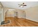 Open-concept living room with hardwood floors, ceiling fan, and arched doorways at 540 Florida S Cir, Apollo Beach, FL 33572