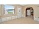 Bright living space with tile flooring, white door and archway leading to kitchen at 540 Florida S Cir, Apollo Beach, FL 33572