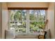 Bright window seat featuring a view of lush greenery and a guitar on the bench at 126 Alora Ne St, St Petersburg, FL 33704