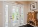 Inviting foyer with a glass front door and classic hardwood floors offering an inviting entryway at 135 Aranda Ne St, St Petersburg, FL 33704