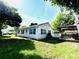 Exterior view of home with a well-maintained lawn and covered patio at 14124 Plum Ln, Hudson, FL 34667