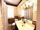Bathroom features a vanity with sink, shower with curtain, and window at 14124 Plum Ln, Hudson, FL 34667