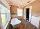 Charming bathroom with clawfoot tub, elegant chandelier, and natural light from the window at 14124 Plum Ln, Hudson, FL 34667