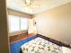 Bright bedroom with a ceiling fan, natural light, and a view into the hallway at 14124 Plum Ln, Hudson, FL 34667