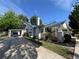 Inviting home showcasing a long driveway, a carport, and well-manicured landscaping at 14124 Plum Ln, Hudson, FL 34667