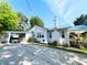 Charming home with carport, well-maintained lawn, and manicured landscaping at 14124 Plum Ln, Hudson, FL 34667